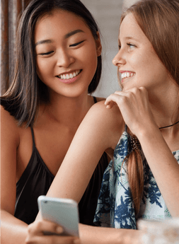 Two Girls Are Talking and Seeing in the Mobile Screen - Mortie