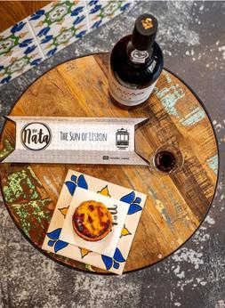 Wine bottle and pistel de nata on the table
